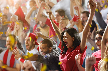 People in a crowd cheering and celebrating