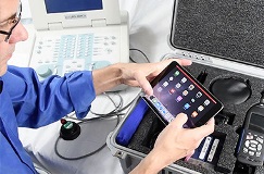 Person holding an IPad over a Spartan Kit